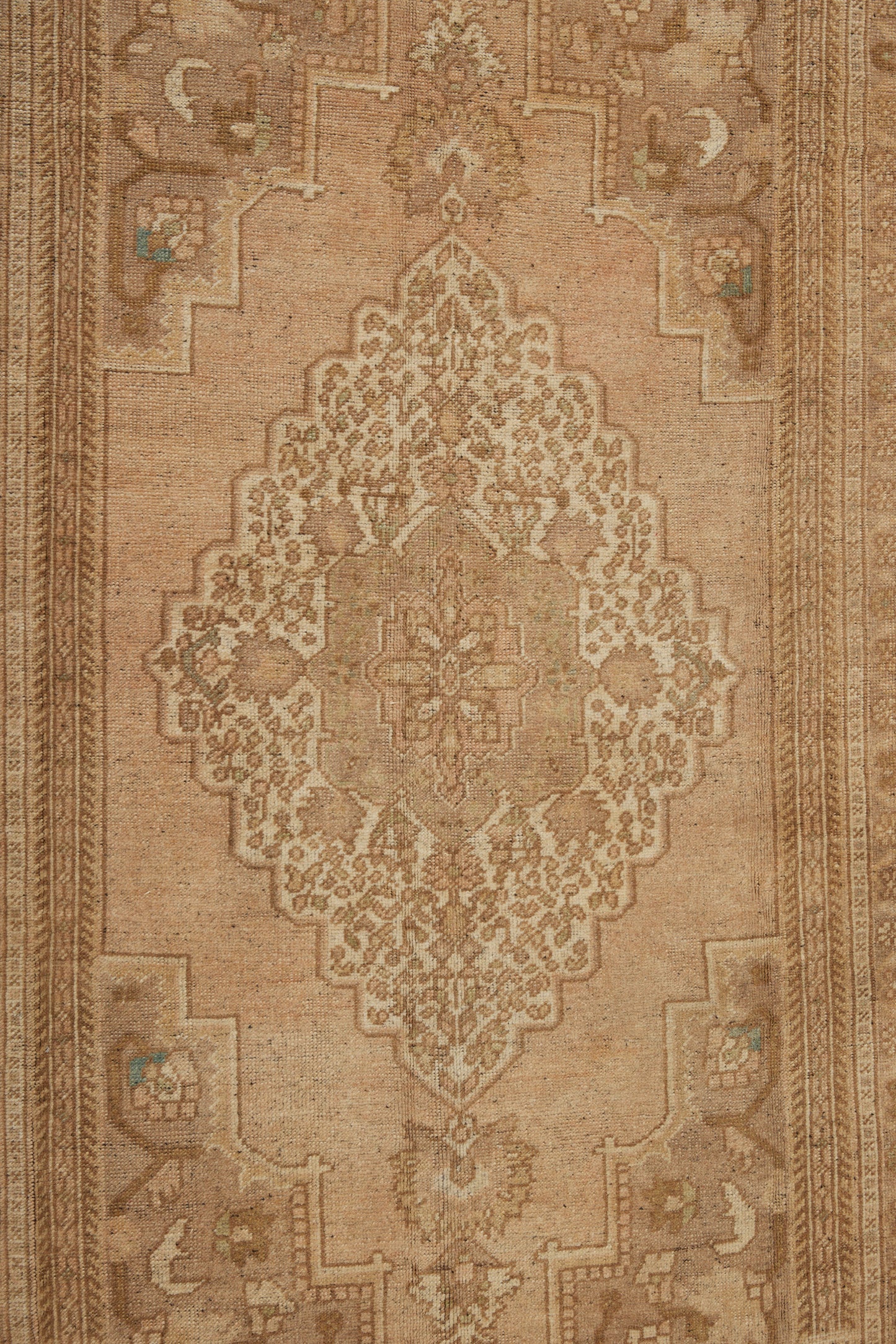 Central Anatolian Carpet with a Central Medallion with Pale Creams and Tans (5' 4" x 9' 7")