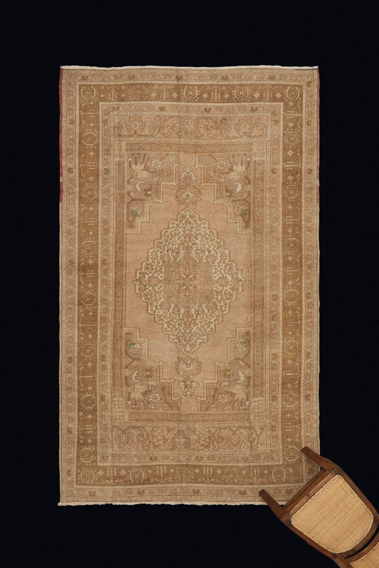 Central Anatolian Carpet with a Central Medallion with Pale Creams and Tans (5' 4" x 9' 7")