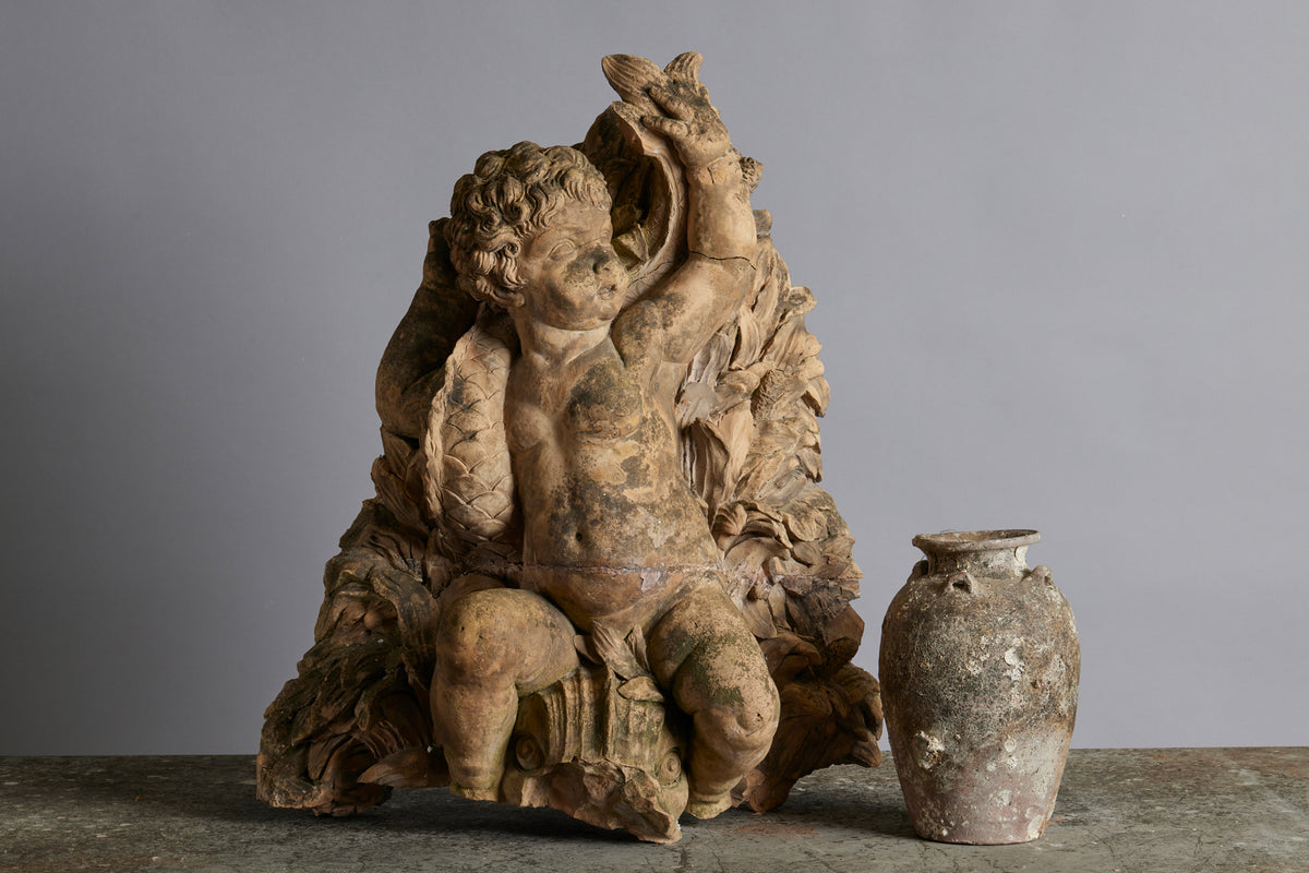 Mid to Late 18th Century Terra Cotta Fountainhead of a Putti Riding a Dolphin
