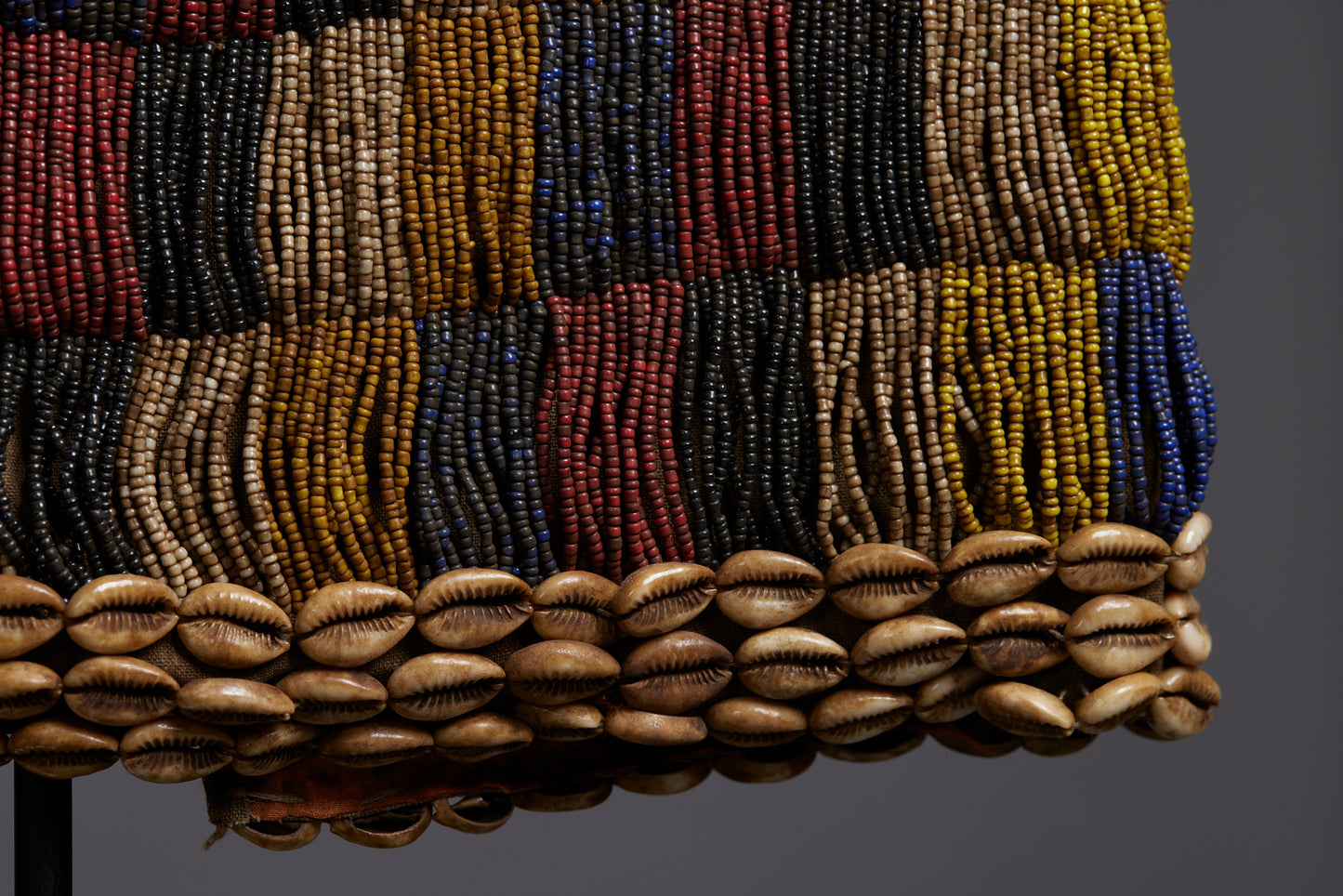 Rare Beadwork Shaman's Vest from Borneo Mounted on an Iron Base with a Cowrie Shell and Trade Beads