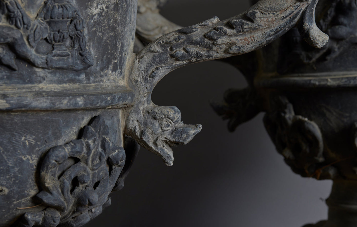 Set of Four English Late 19th Century Cast Lead Urns with Griffin Handles and Cast Applied Puttis in a Challased Form